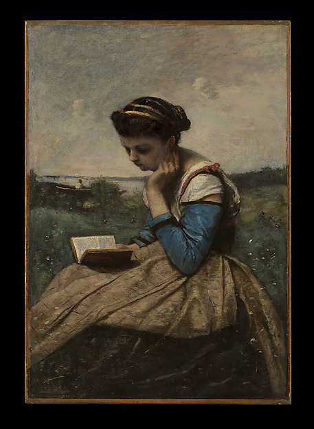 A woman reading quietly beside a tree