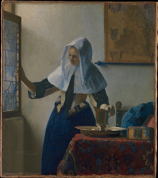 a woman standing by a window with a water pitcher and basin